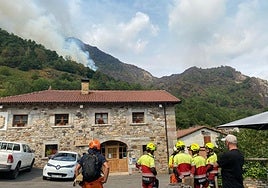 Bomberos procedentes de Grado y Pravia se reorganizan en Caunedo (Somiedo) para tratar de sofocar uno de los principales focos. Jorge Hurlé