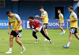Álvaro atrapa un balón con Adri Gómez, Jose Martínez y Viti formando línea defensiva.