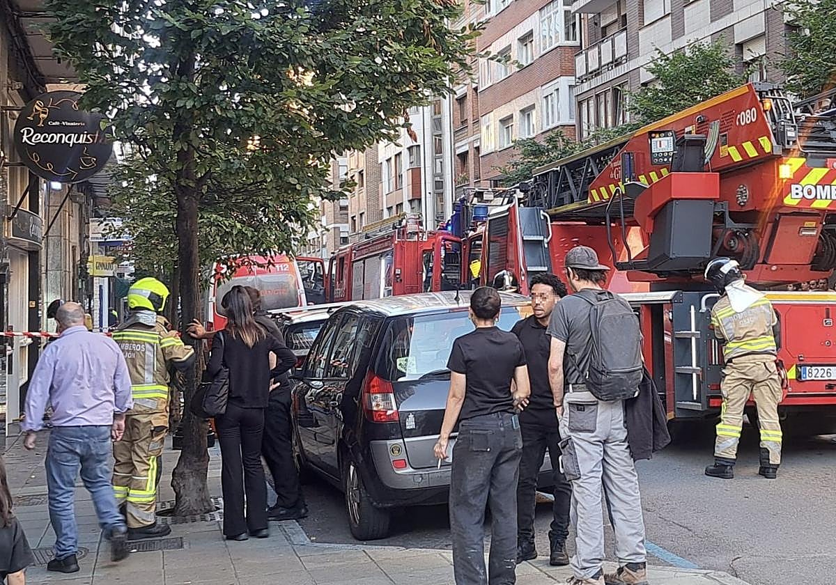 Dos camiones de bomberos y ambulancia ante la cafetería de la calle Aguado en cuya cocina se produjo el fuego.
