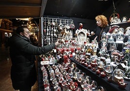 Adrián Barbón visita uno de los puestos de artesanía del mercado de Navidad de Oviedo.