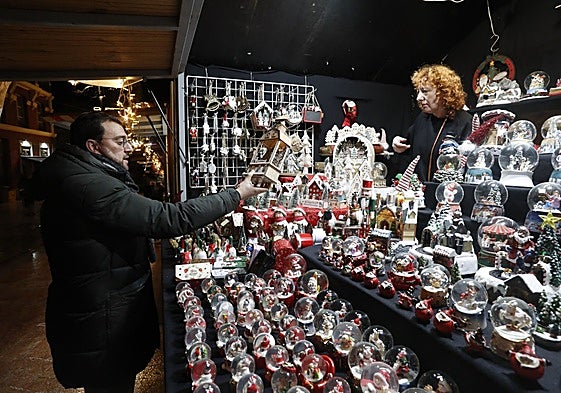 Adrián Barbón visita uno de los puestos de artesanía del mercado de Navidad de Oviedo.