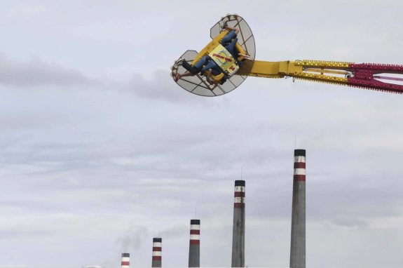 Una de las atracciones del recinto ferial, con las chimeneas de Baterías de Cok de fondo. 