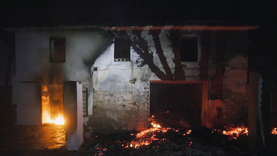 Una casa ardiendo en La Caridad durante los incendios de diciembre de 2015.