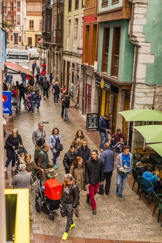 Visitantes paseando por una céntrica calle de Llanes.