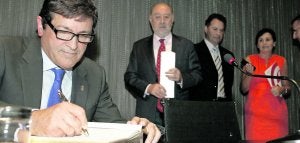 Javier Fernández estampa su firma en el libro de honor de la Fidma, ante Gabino de Lorenzo, Félix Baragaño y Carmen Moriyón. ::                             LUIS SEVILLA