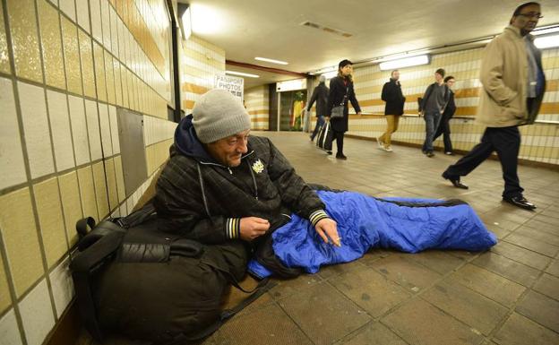 Un hombre sin hogar duerme en la estación de Charing Cross en Londres.