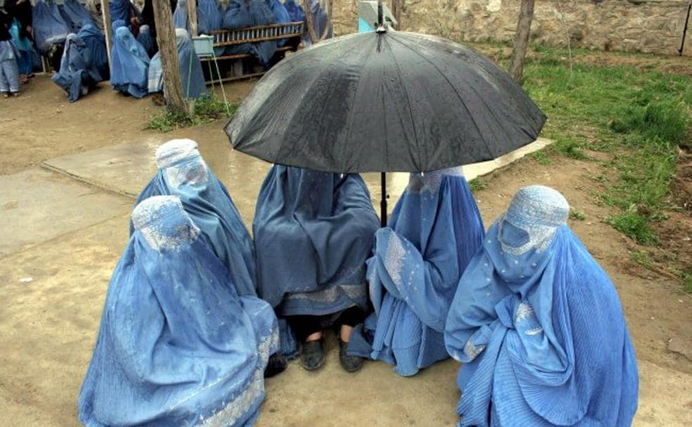 Con burka. Un grupo de mujeres afganas esperan para recibir ayuda humanitaria en Kabul. 