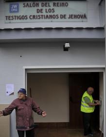 Imagen secundaria 2 - Carmen Jiménez, con su familia, asomada a la ventana por donde intentaron robarle. El pescadero Sergio López analiza la situación en su puesto del mercado. Julián Jiménez explica lo ocurrido el miércoles en su sede.