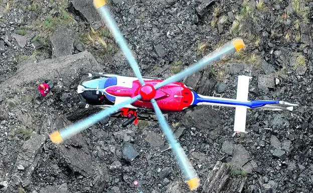 El helicóptero se dispone a elevar con una grúa a un ertzaina con el cadáver de una persona hallada a los pies del Salto del Nervión.