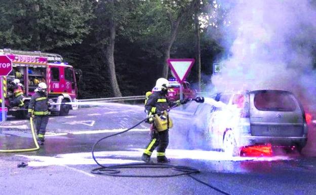 Bomberos de Castro Urdiales sofocan el coche incendiado.