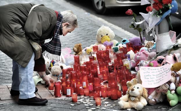 Una señora deposita una vela en el lugar donde falleció la pequeña. 