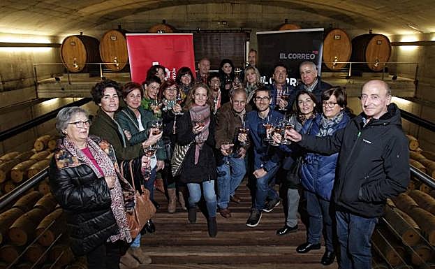 Los suscriptores brindan en la sala de barricas de Baigorri.
