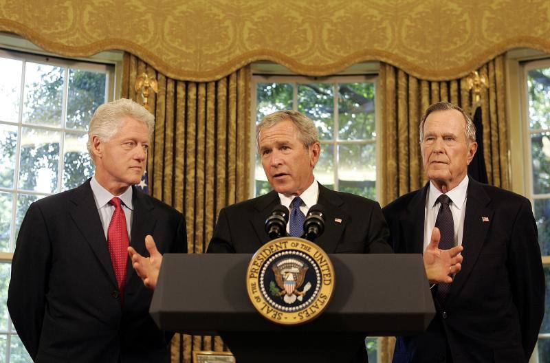George H. W. Bush junto a su hijo (centro) y al expresidente Bill Clinton.