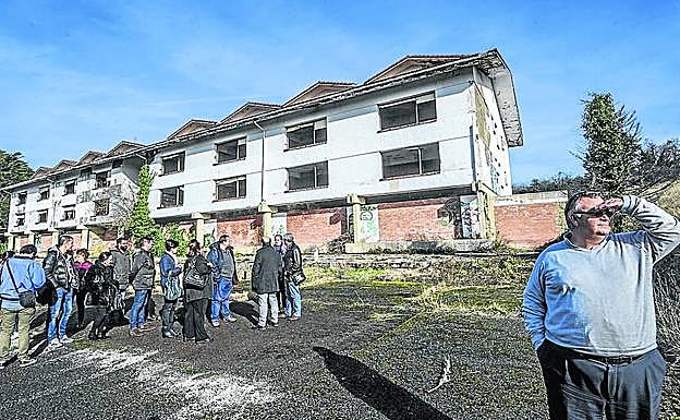 Guinea mira al horizonte mientras el grupo observa la que fue residencia masculina. 