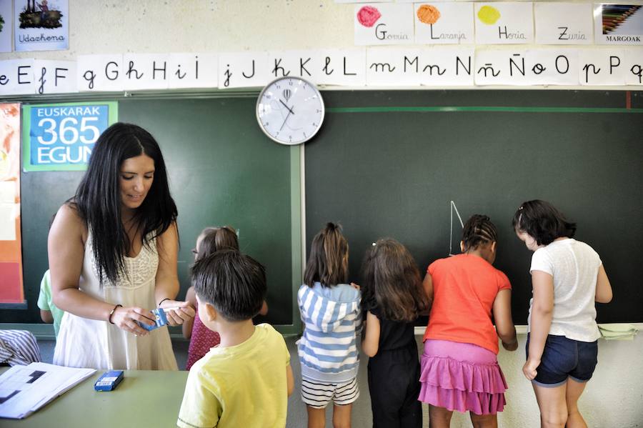 Haur batzuk, irakaslearekin, klaseko lehenengo egunean.