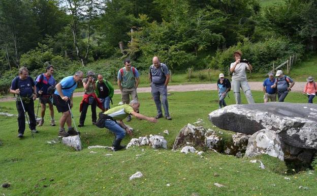 Un guía explica las características del dolmen de Jentilarri, en Ataun