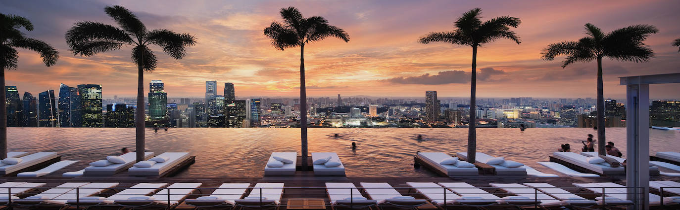 Caro y con la piscina más espectacular | Singapur destaca por muchas cosas, entre otras por la espectacular arquitectura que inunda la ciudad. Entre sus edificios destaca uno que es casino, el Marina Bay que además está considerado como el casino independiente más costoso del planeta y en el que su propietaria, Las Vegas Sands, invirtió 4.100 millones de euros en su construcción. El complejo, diseñado por Moshe Safdie arquitectos, cuenta con tres torres hoteleras, un centro de convenciones y exposiciones, un centro comercial, un museo de Arte y Ciencia, dos teatros, seis restaurantes y dos pabellones flotantes. Pero, seguramente, lo que más llama la atención es la increíble piscina situada en una plataforma elevada al aire libre sobre las tres torres del edificio, el Sands Sky Park, y está construida en acero inoxidable con una capacidad de 1440 m³ de agua. Su espectacularidad nace gracias al borde invisible en el que termina la misma. Como no podría ser de otra forma el nombre de la piscina es Infinity Pool (Piscina Infinita). 