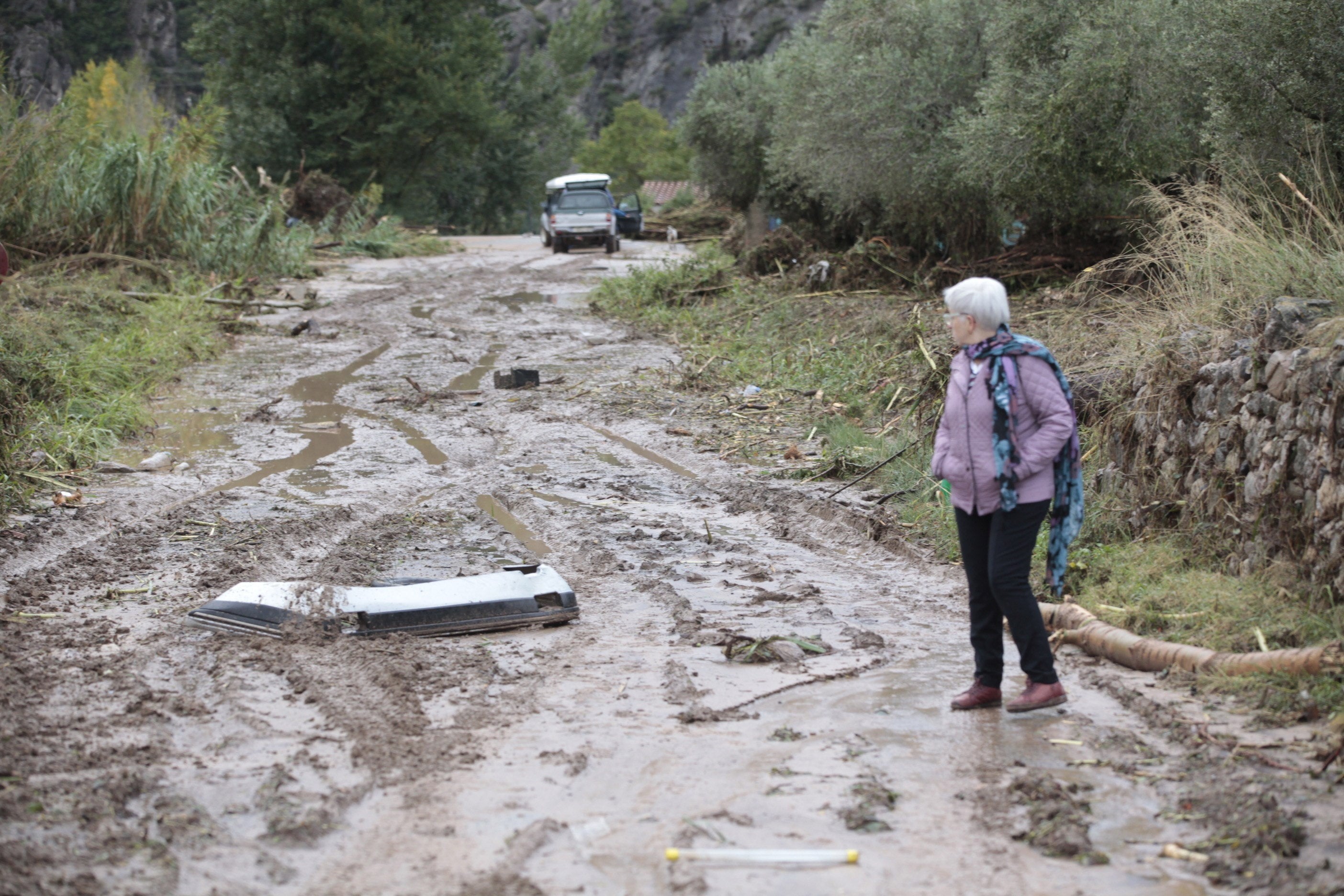 Una mujer observa cómo ha quedado una carretera tras el temporal