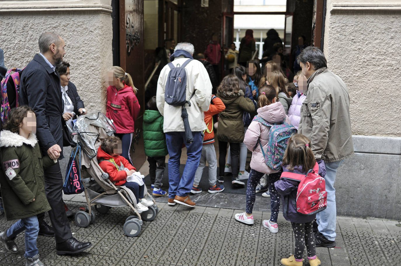 Niños y niñas de todas las edades entran al Colegio de Escolapios en Bilbao.