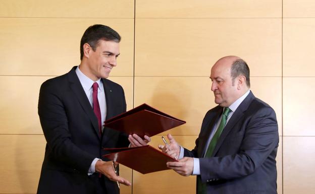 El presidente en funciones, Pedro Sanchez, y el presidente del PNV, Andoni Ortuzar, firman el acuerdo para la investidura