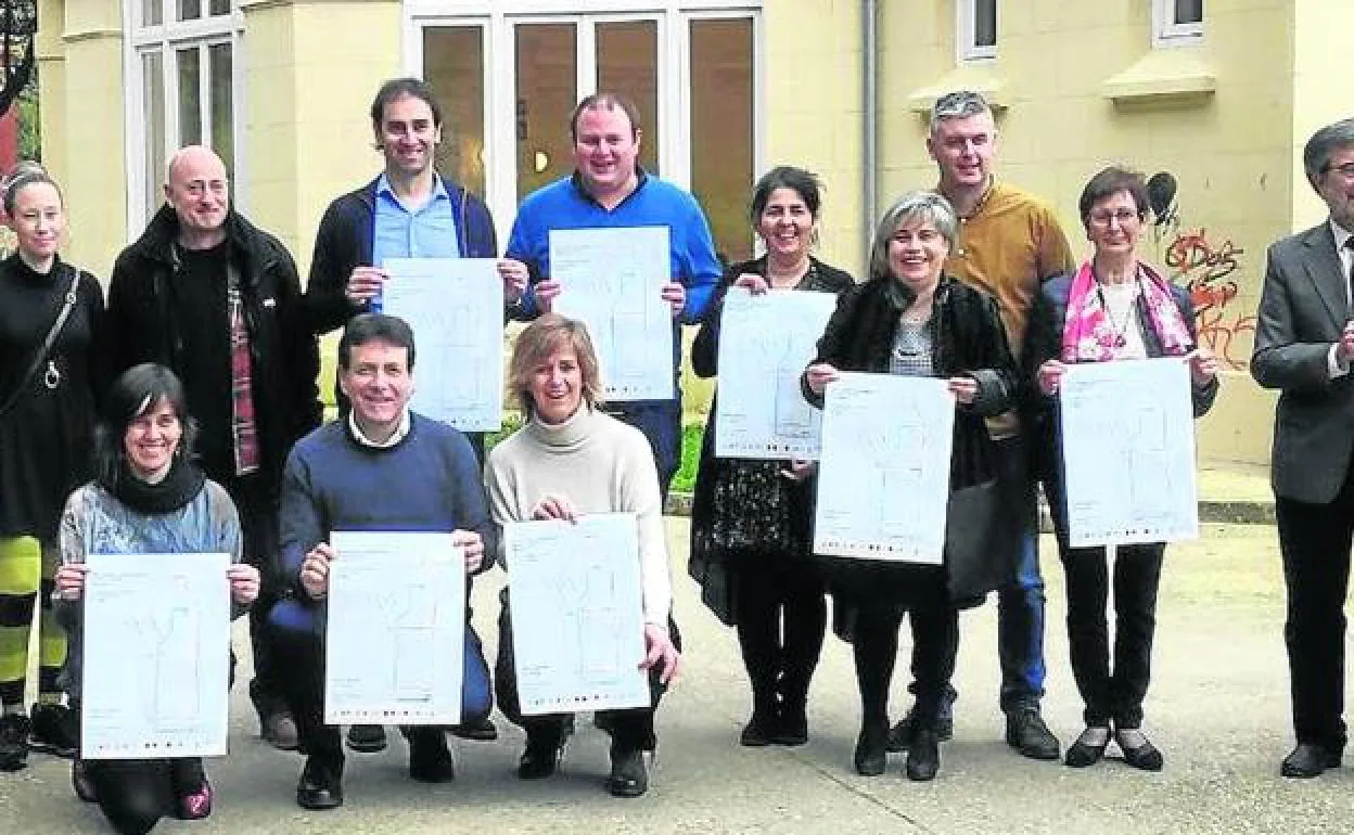 Alcaldes y representantes municipales de la comarca posan con los carteles que se colocarán en las estaciones.