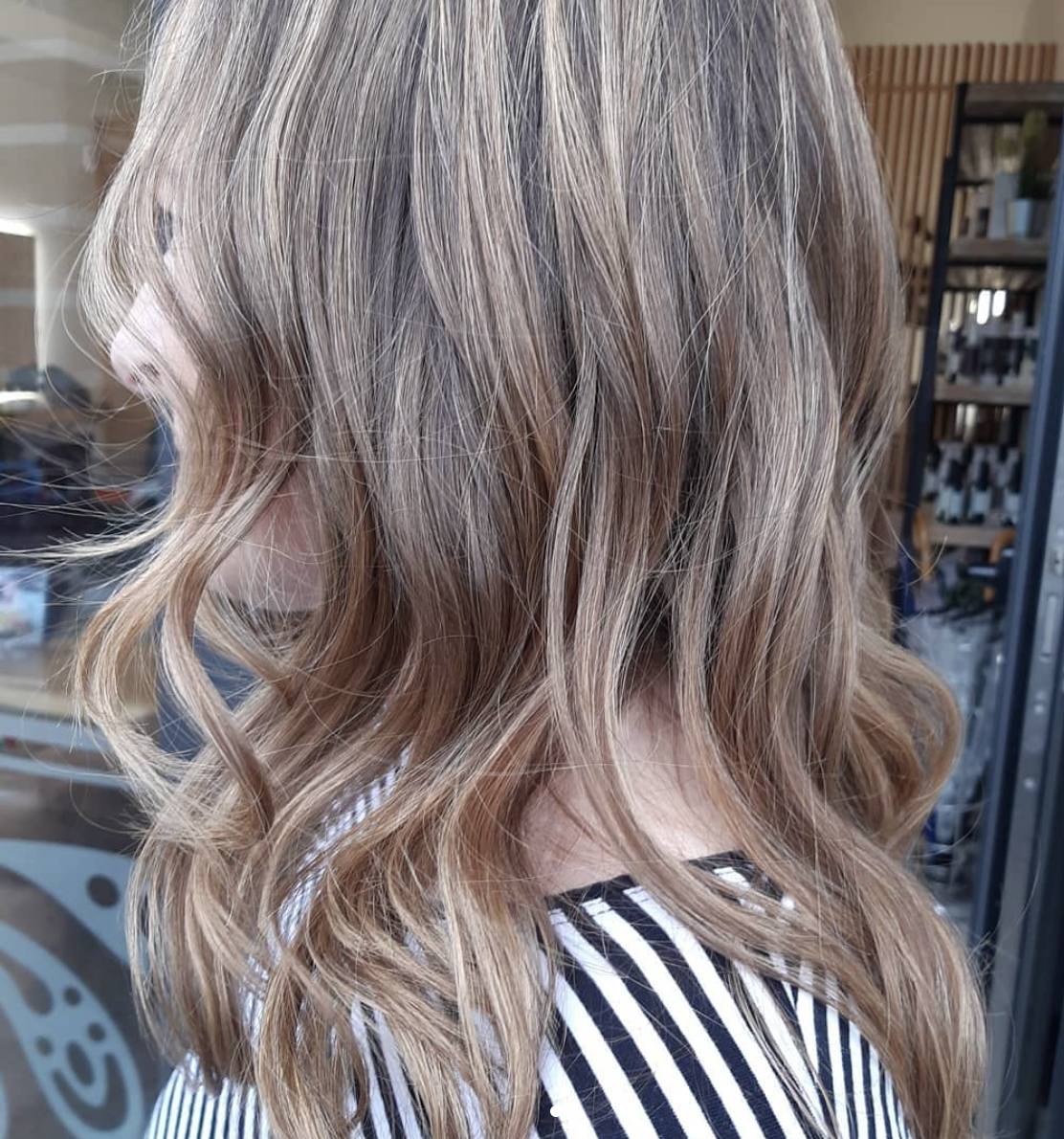 Melena larga con color degradado rubio, realizado a través de barros.