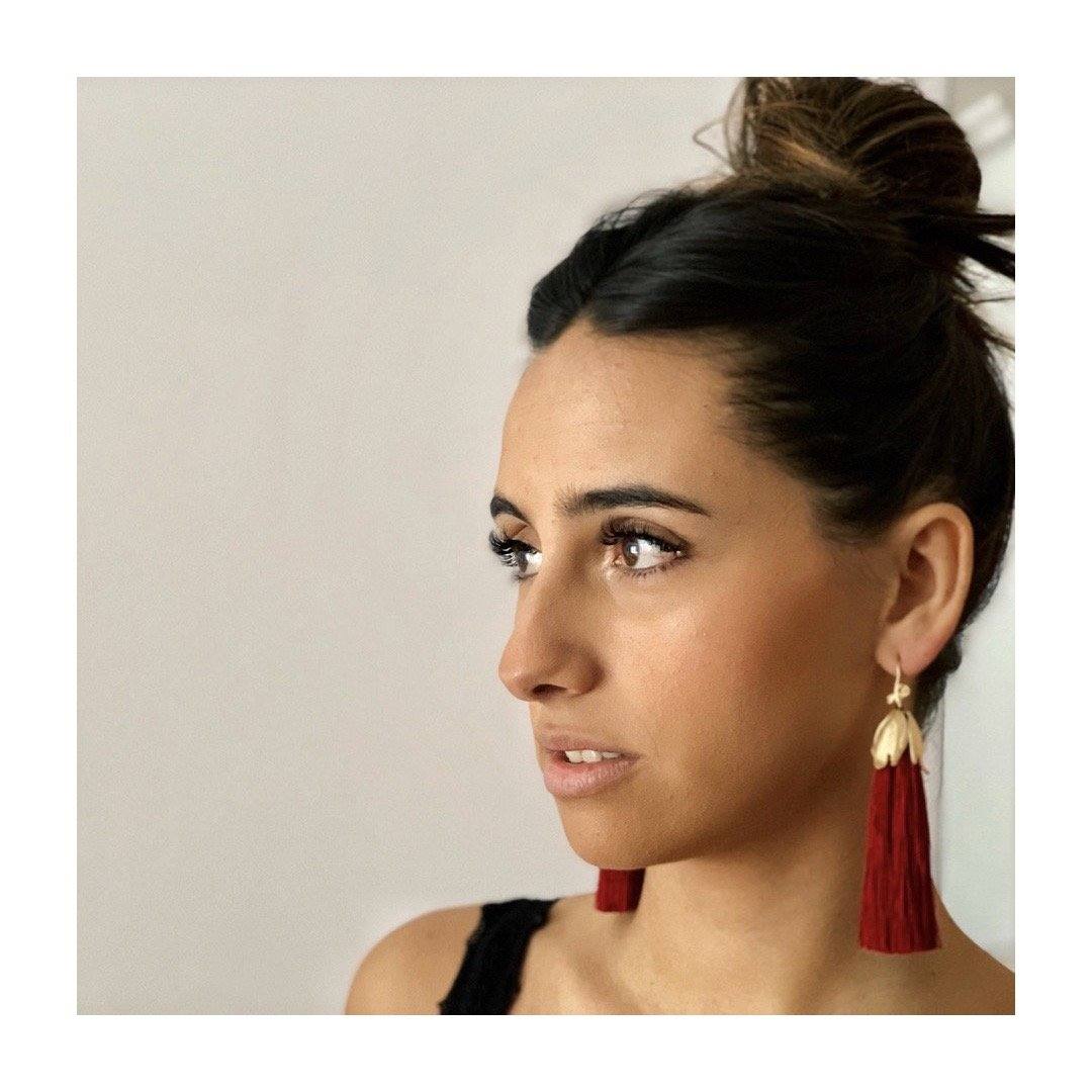 Pendientes largos Frida, de la firma vizcaína Sinun. Están fabricados en latón bañado en oro con un largo pompón en tonos granates. Costaban 39,95 y ahora lo puedes encontrar por 27,95 euros.