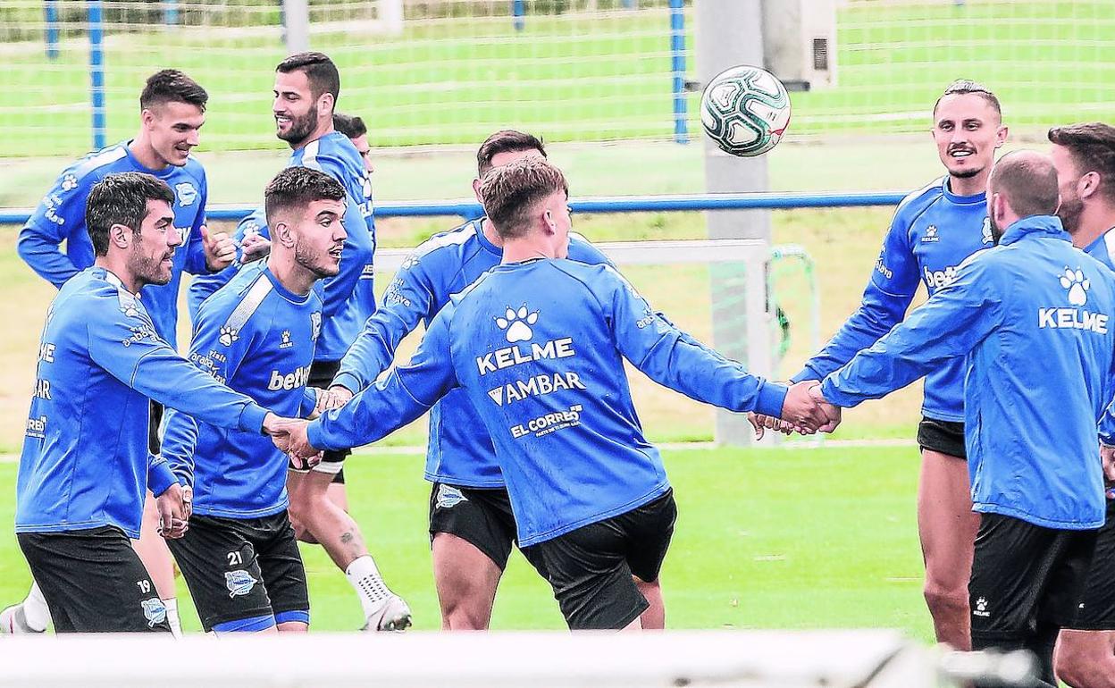 Los jugadores albiazules hacen un ejercicio colectivo de calentamiento en el entrenamiento de ayer en Ibaia. 