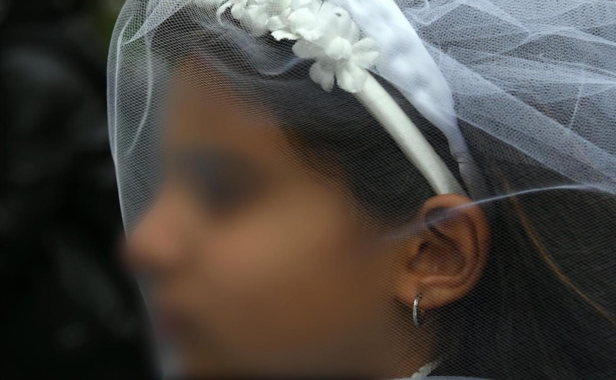 Una niña vestida con vestido y velo de novia, imagen de una campaña de Unicef contra el matrimonio infantil. 
