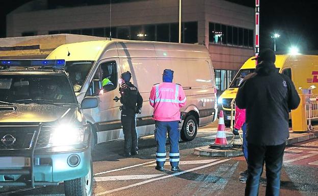 Imagen principal - La Guardia Civil entrega las dosis a las empresas de transporte, custodiadas por las Ertzaintza. Las dosis para Euskadi llegan a la empresa Bexen Medical de Hernani, donde se conservan hasta su uso. Un operario de Bexen revisa las cajas con las dosis. 