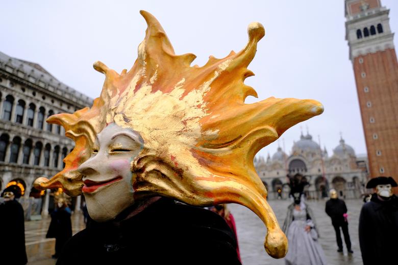 Un juerguista lleva una máscara de carnaval en la Plaza de San Marcos para celebrar el carnaval anual de Venecia, que ha sido cancelado este año debido a la pandemia de coronavirus.