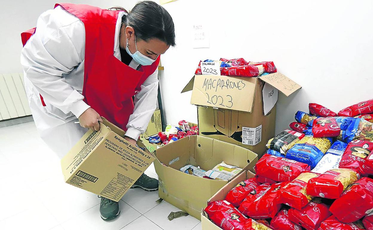 Una voluntaria clasifica alimentos en los locales de la calle Sorribas. 