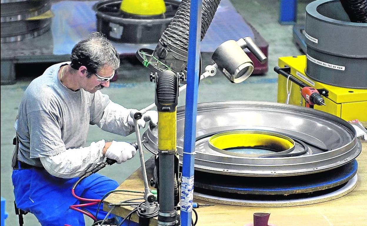 Imagen de un operario de ITP mecanizando la pieza de un motor. 