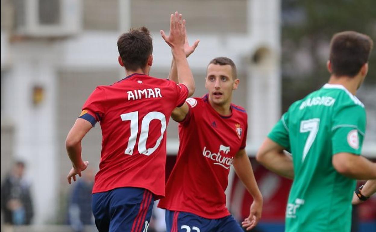 Dos jugadores de Osasuna se saludan durante el encuentro.