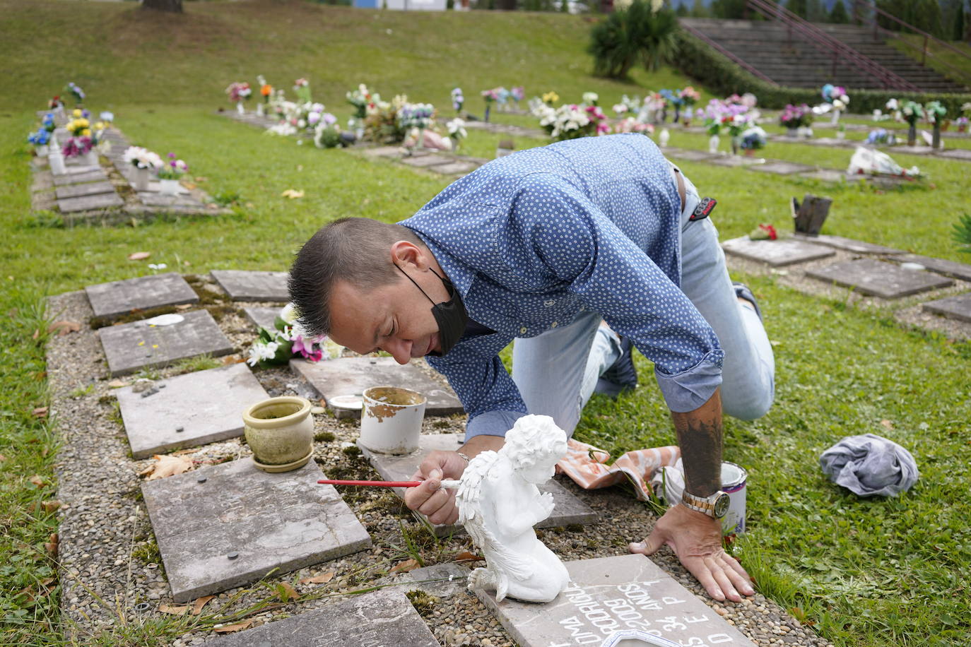 Con amor. Jonatan Freijamil pìnta de blanco un ángel que colocó sobre el nicho de su hermana fallecida.
