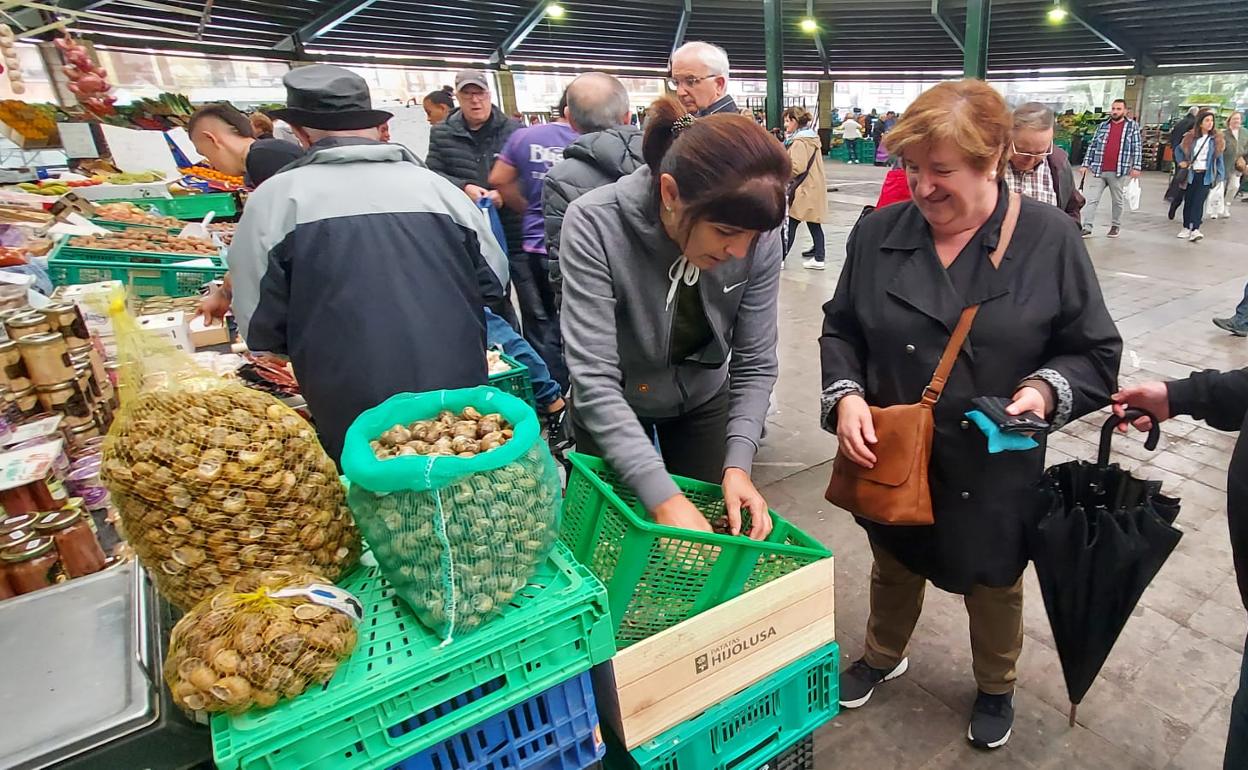 Un matrimonio se dispone a comprar varios kilos de caracoles en la sesión de mercado de ayer en Gernika. 