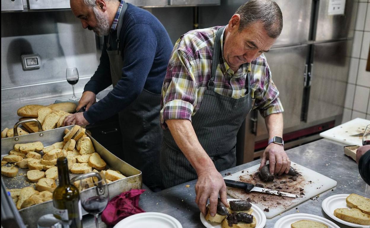 Dos participantes elaboran pintxos de morcilla en una de las sociedades de Elorrio. 