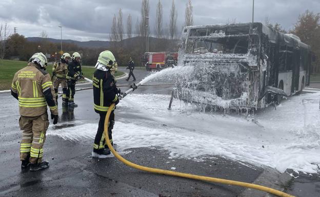 Los bomberos sofocan las llamas que han calcinado el autobús. 