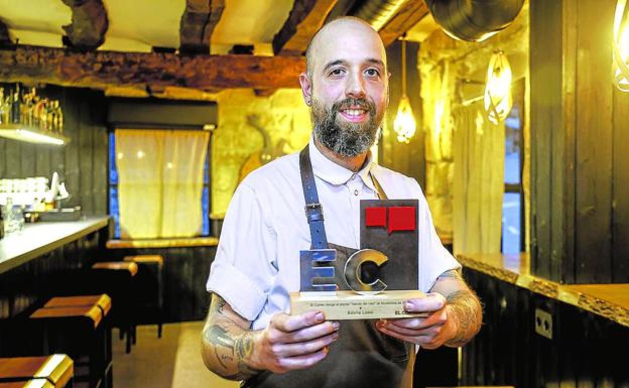 El chef Edorta Lamo sostiene en su restaurante de Campezo el trofeo de Alavés del Mes que otorga EL CORREO. 