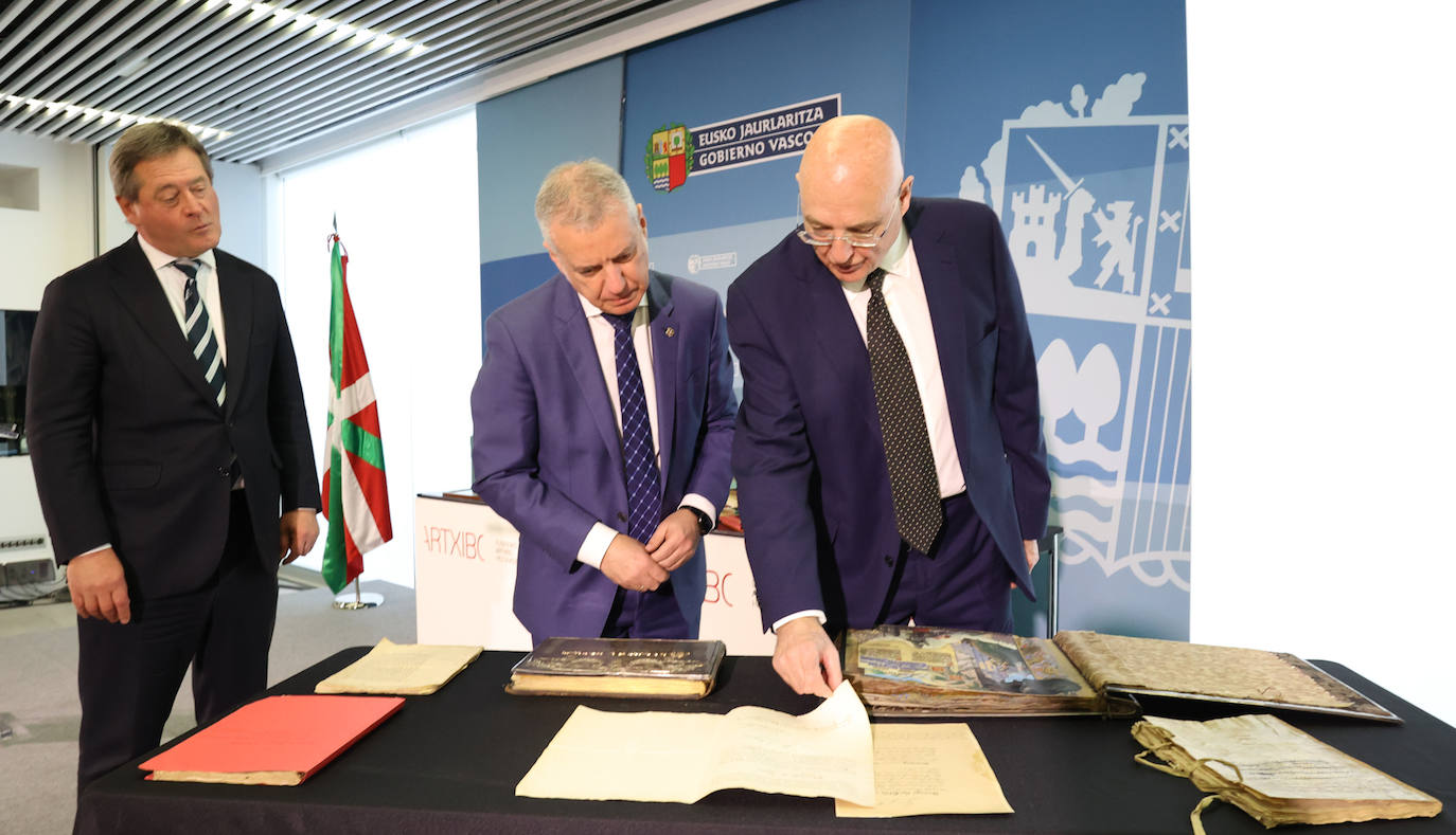 Bingen Zupiria, Iñigo Urkullu y Ramón de la Sota Zorraquín observan algunos de los documentos entregados por la familia.