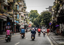 Varias motos circulan por una calle de una ciudad vietnamita.