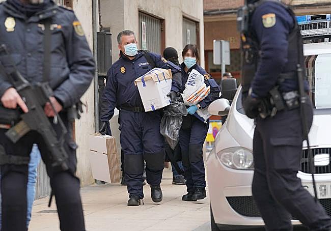 Efectivos policiales sacan varias cajas con supuestas evidencias.