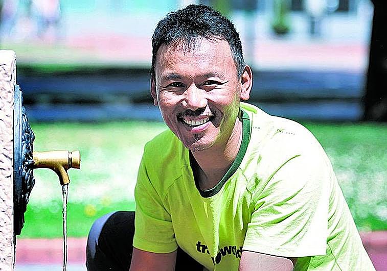 Cheppal Sherpa bebe agua de una fuente en el centro de Bilbao.