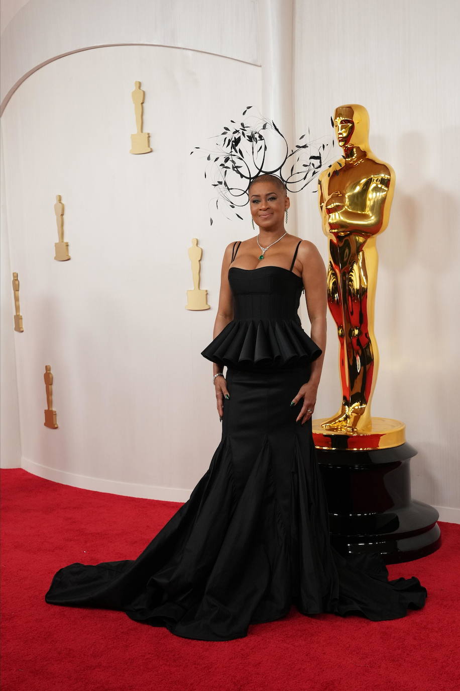 Un tocado gigante con plumas, pendientes, collar, volantes... Demasiadas cosas juntas en el estilismo de Jacqueline Stewart, directora y presidenta del Academy Museum of Motion Pictures.