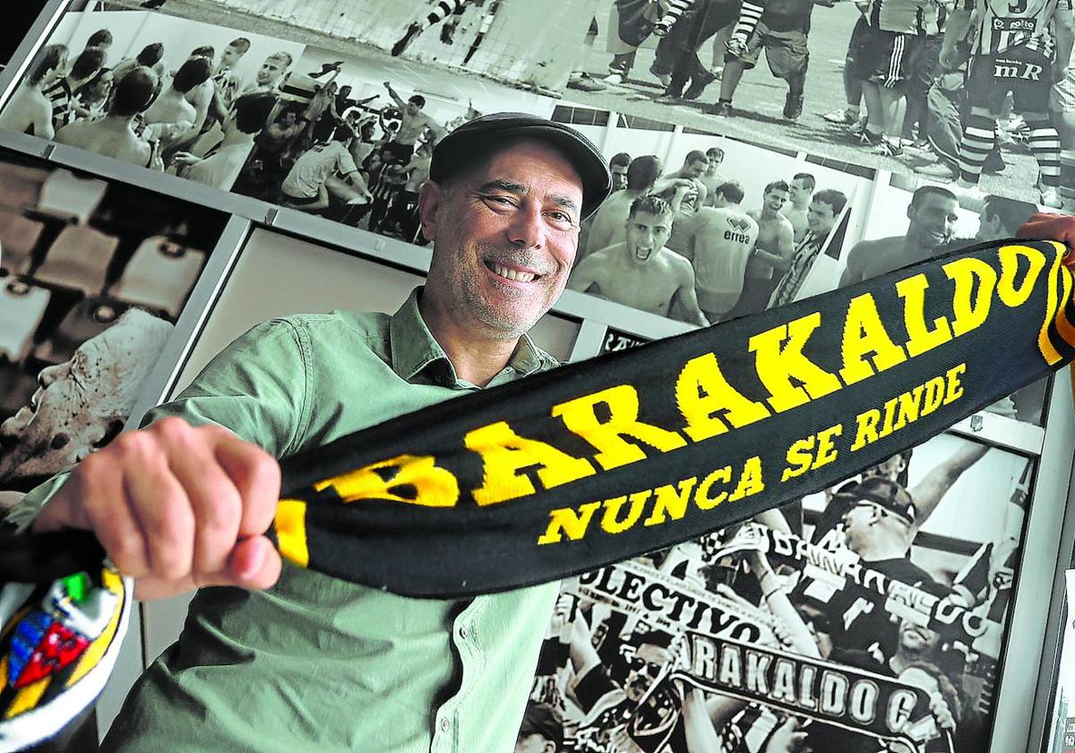 Ricardo Arana posa sonriente con una bandera del Barakaldo tras la entrevista realizada ayer en Lasesarre.