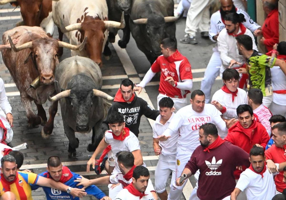 Uno de los miembros de la kuadrilla con la camiseta en honor a César García escapa de los toros.