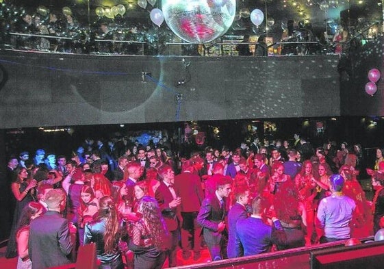 Un grupo de jóvenes disfruta del cotillón en la sala de una discoteca.