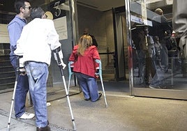 Dos afectados por talidomida acceden a un edificio público.