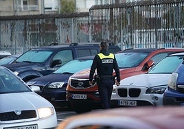 Un agente local multando a coches en doble fila esta mañana de jueves.