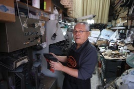 Juan Carlos Rubio repara zapatos en su taller.